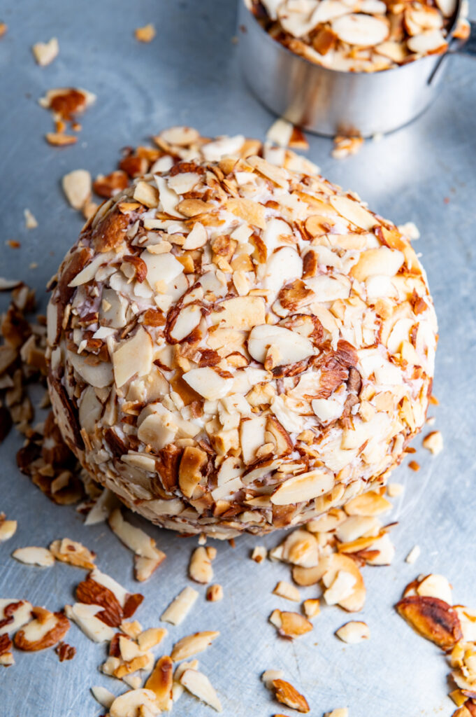 A cheese ball coated in almonds.