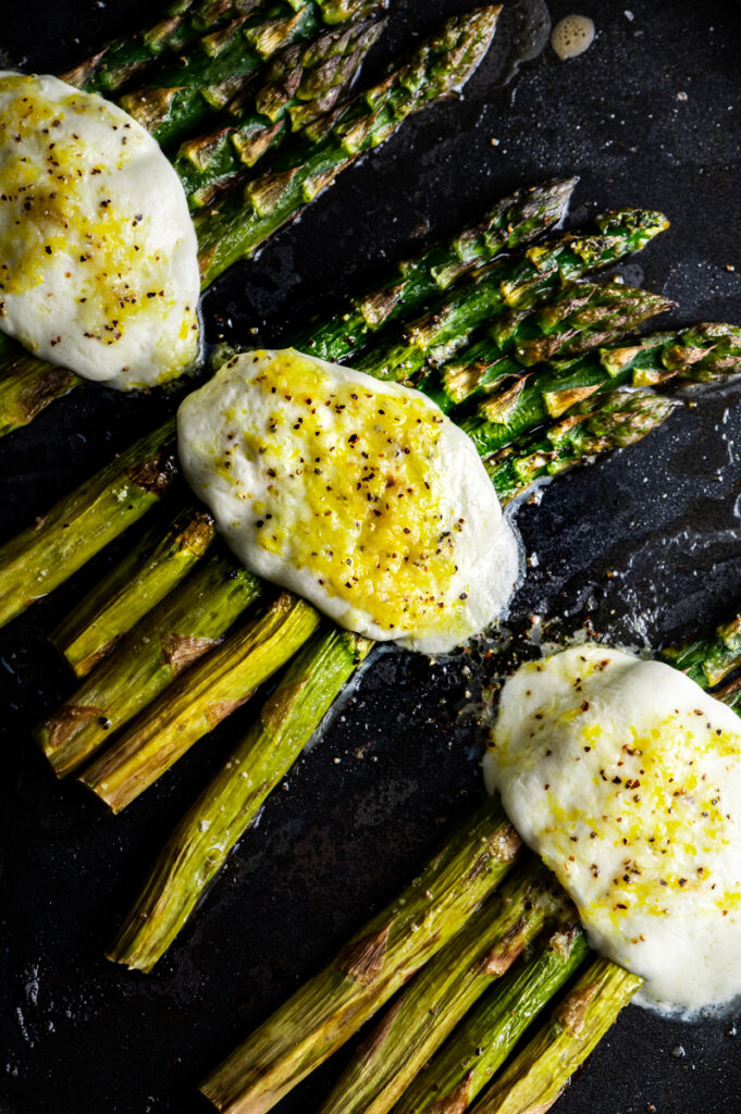 Roasted asparagus with melted mozzarella and lemon dressing.