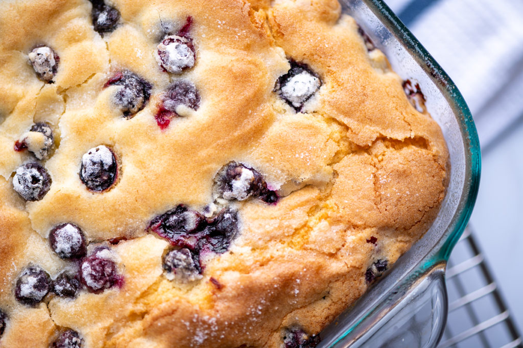 A close view of the top of a blueberry cake.