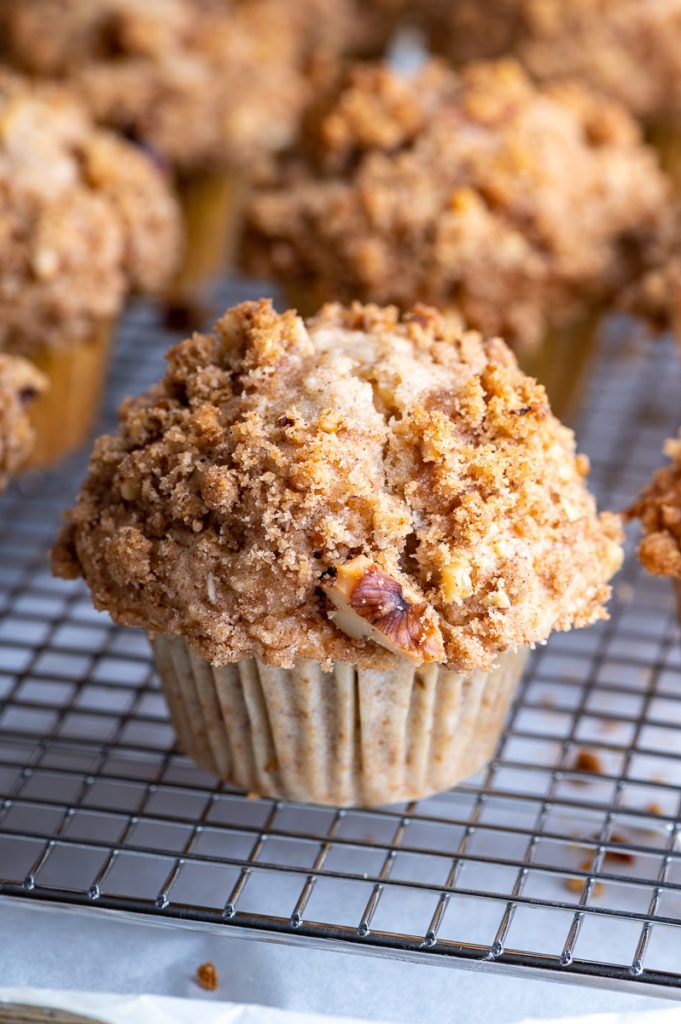 A banana walnut streusel muffin on a cooling rack.