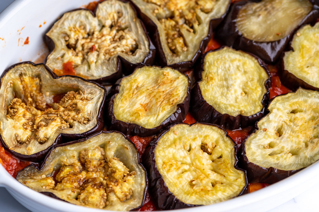 Roasted eggplant slices in a casserole.