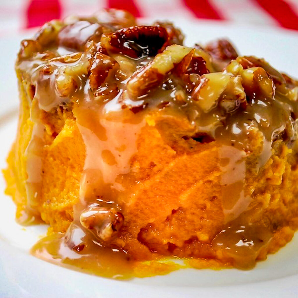 A serving of sweet potato casserole on a white plate.