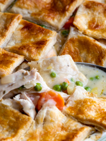 Chicken pot pie being scooped out with a serving spoon.