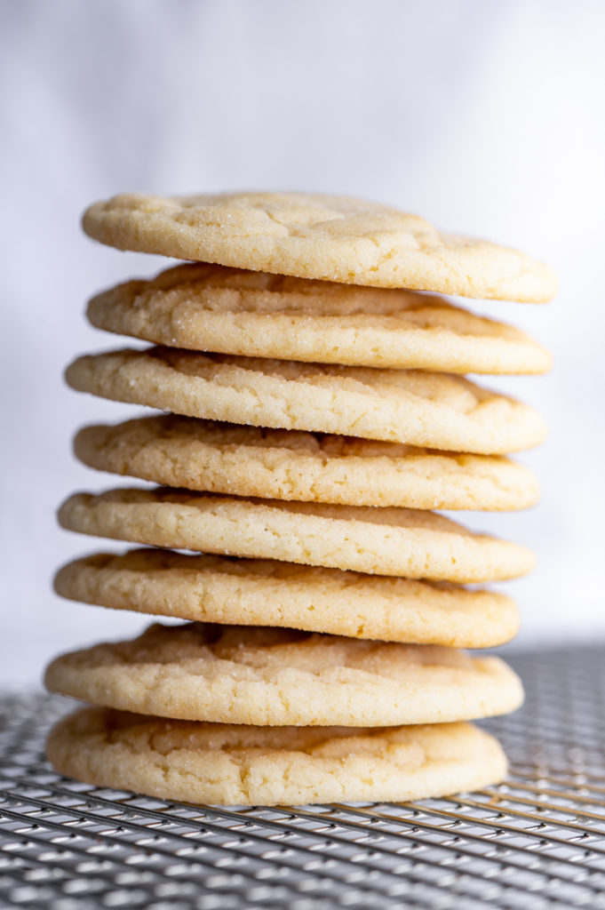 A stack of cookies on a cooling rack.