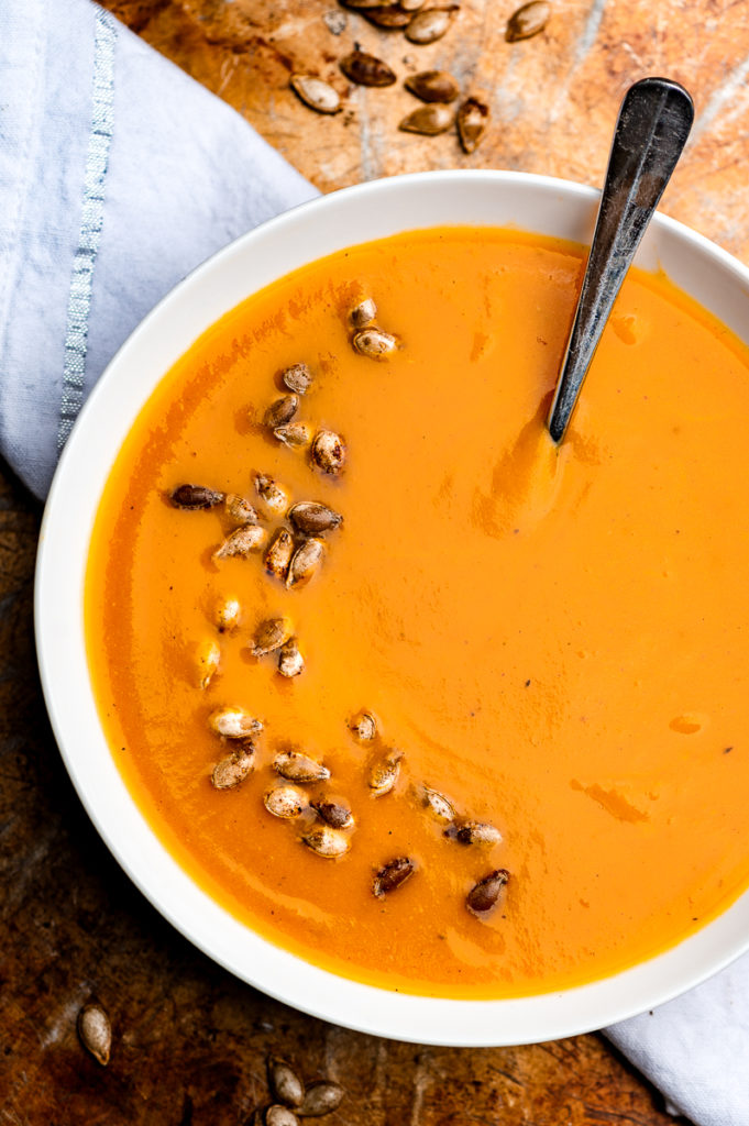 Roasted butternut squash soup garnished with roasted squash seeds.