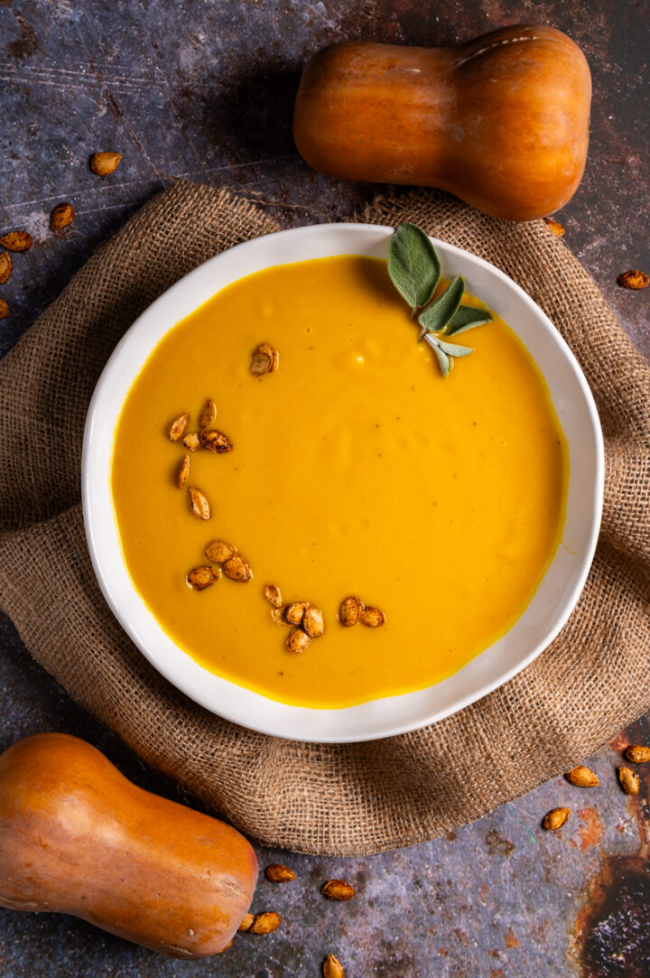 Roasted butternut squash soup garnished with roasted squash seeds.