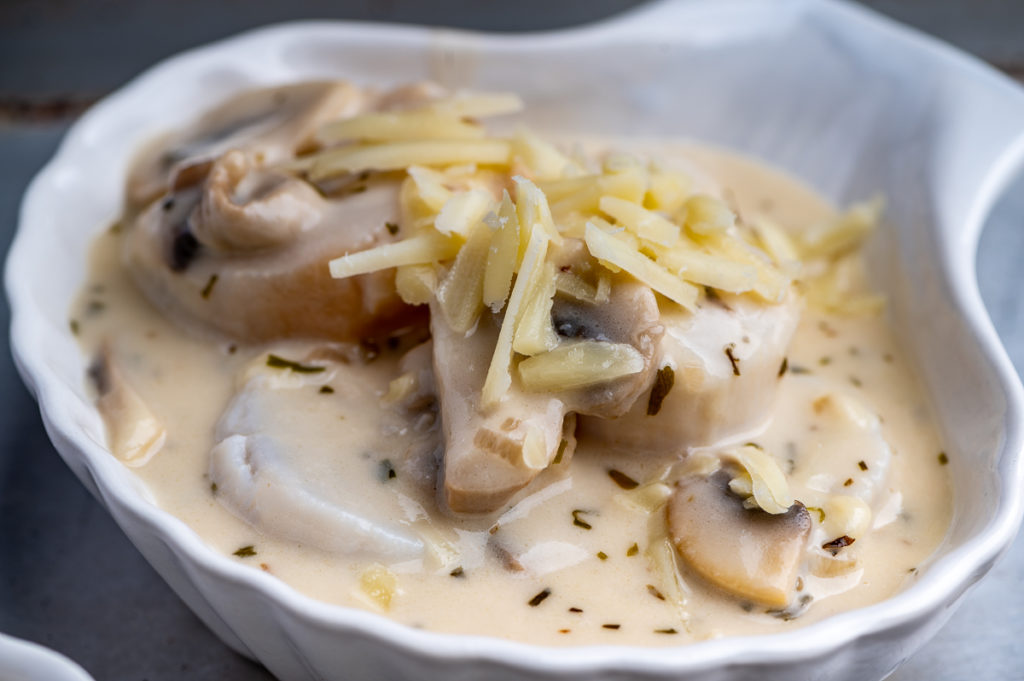 Shredded Gruyere cheese top scallops and mushrooms.