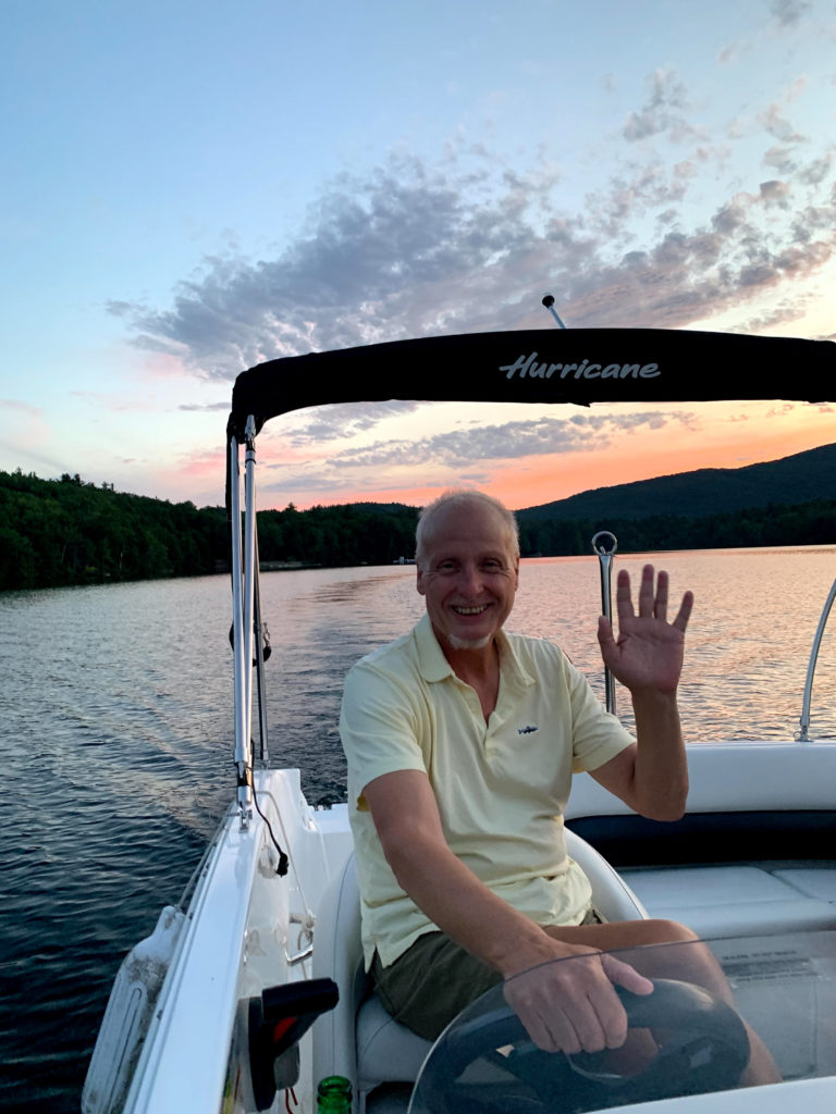 Billy waving on a boat.