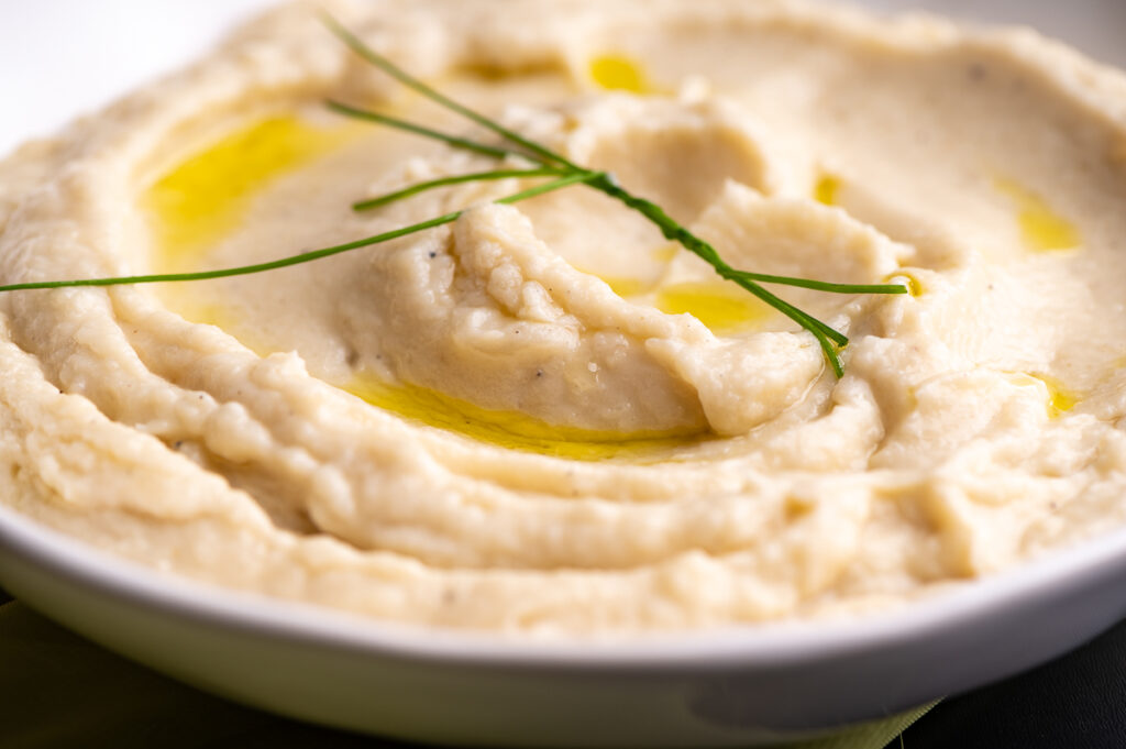 Closeup of mashed cauliflower with a few chives.