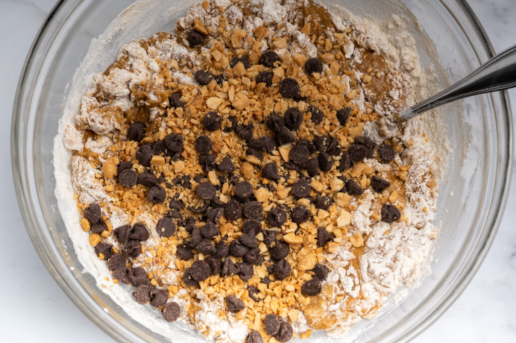 Chocolate chips added to batter in a bowl.