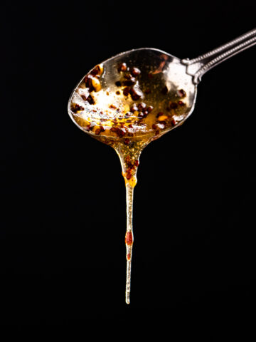 Honey drizzling from a spoon.
