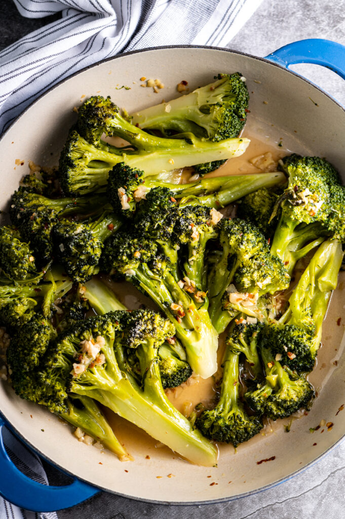 A skillet of sautéed broccoli with garlic and crushed red pepper.