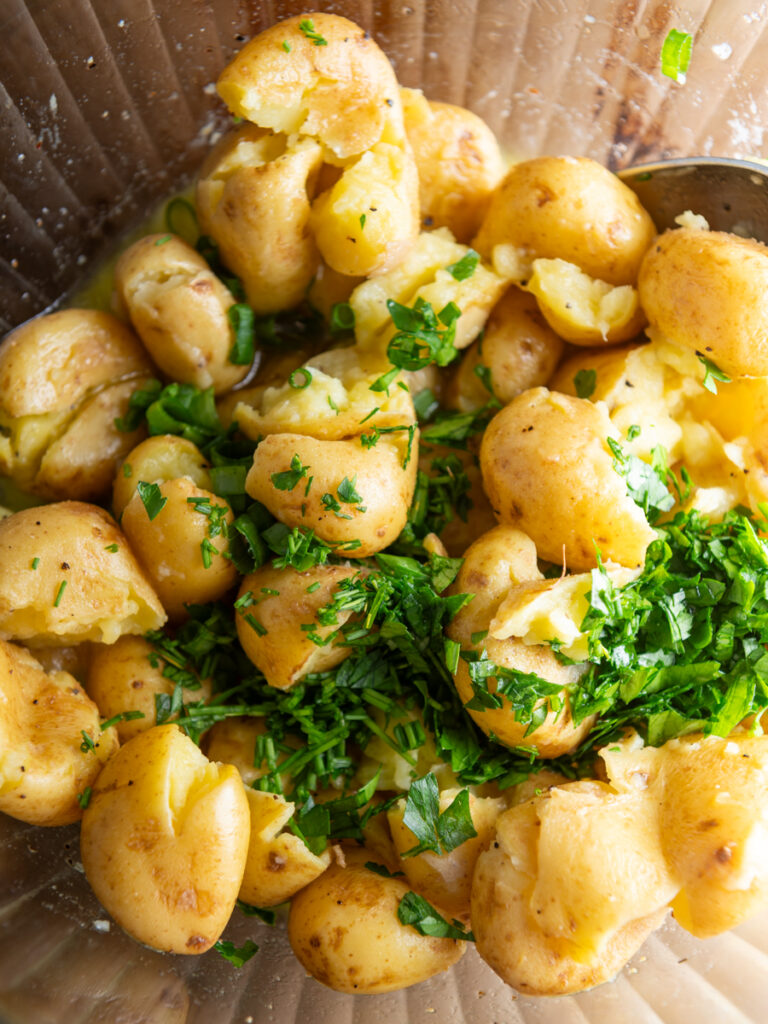 Smashed baby potatoes with chopped herbs.