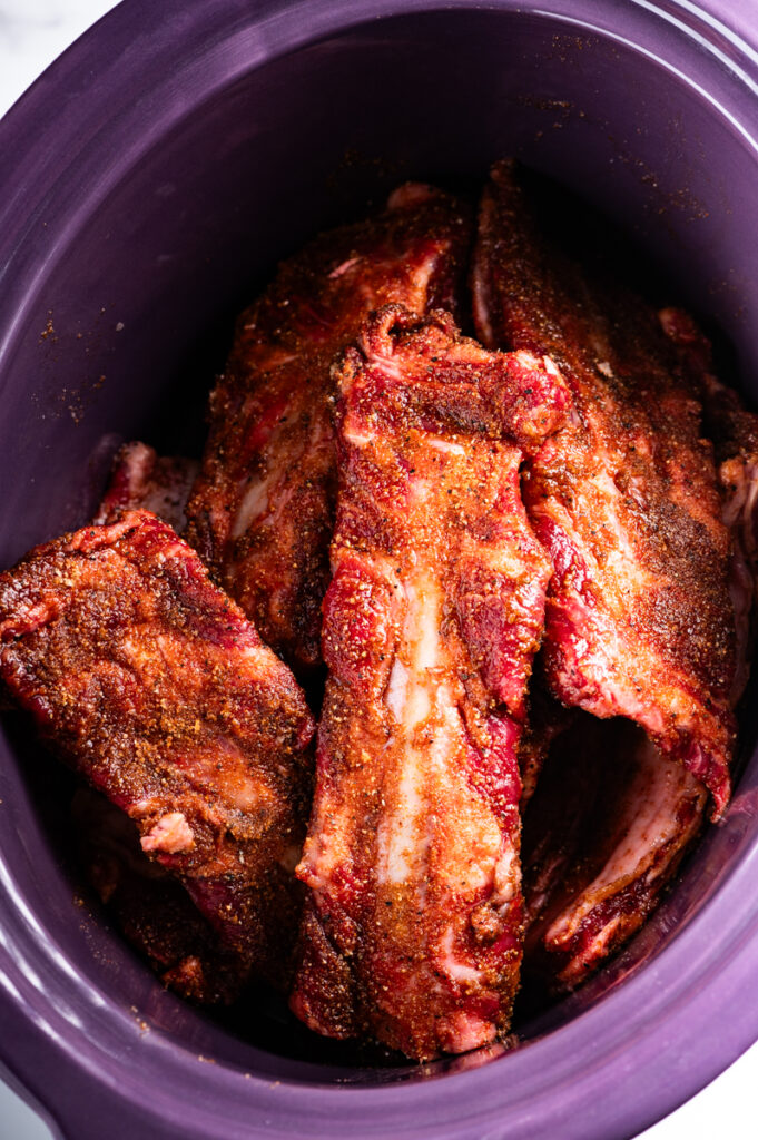 Beef ribs in a slow cooker ready to go.