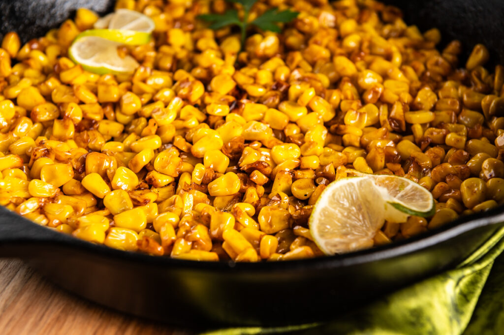 Sideview of a skillet of chili lime corn.