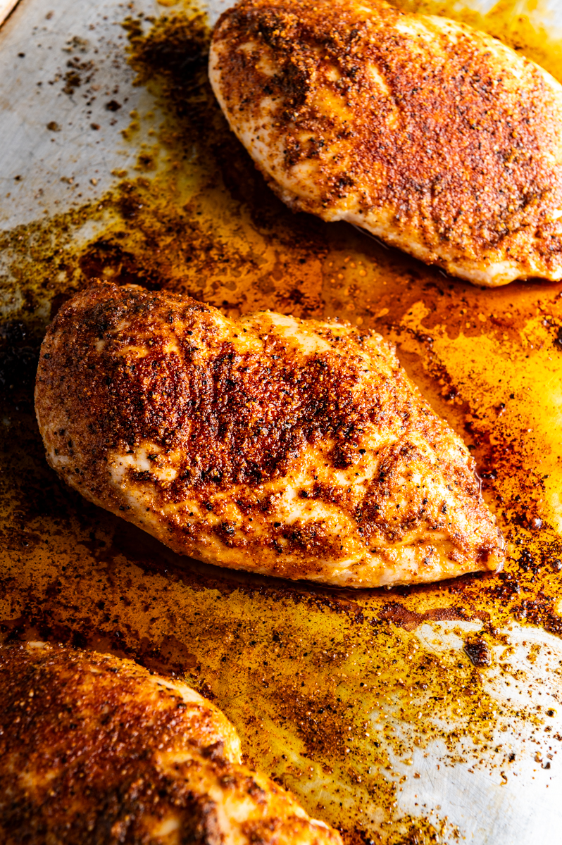 Baked chicken breasts on a baking sheet.