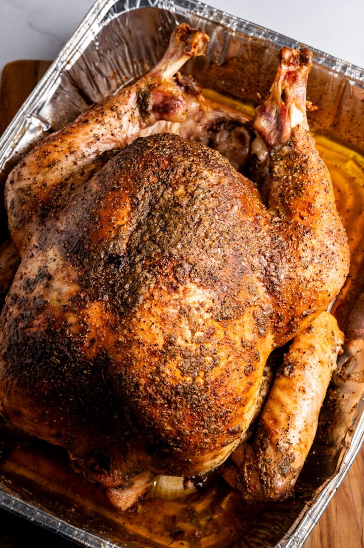 Roasted turkey in a foil pan.