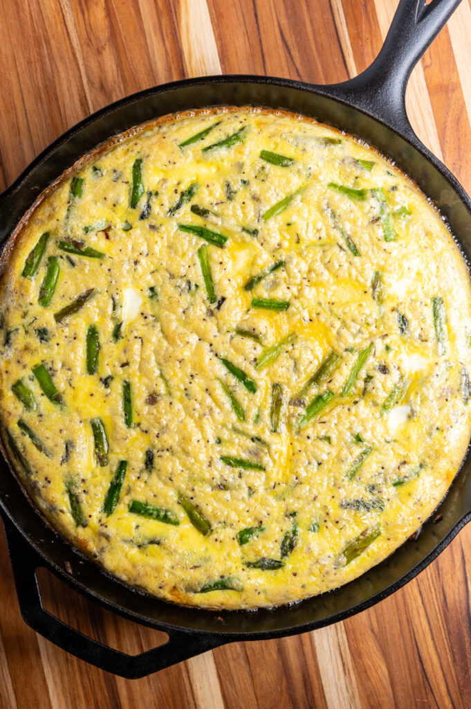 Baked asparagus frittata in a cast iron skillet.